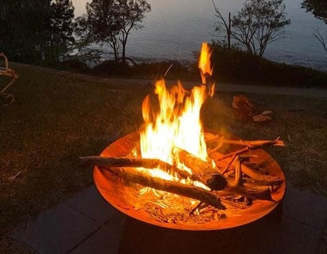 Fire crackling in a corton steel brazier fire pit at night